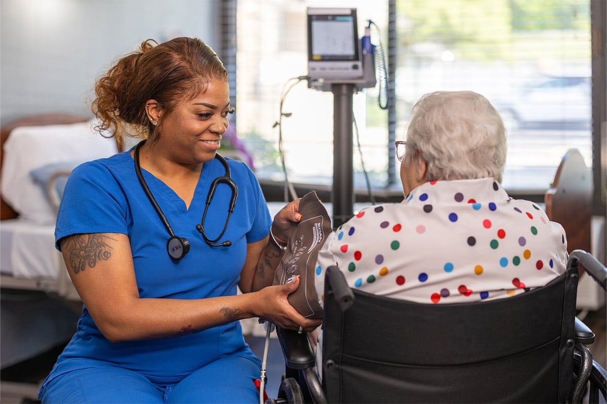 Nurse taking patient's blood pressure at Cedar Creek Post Acute