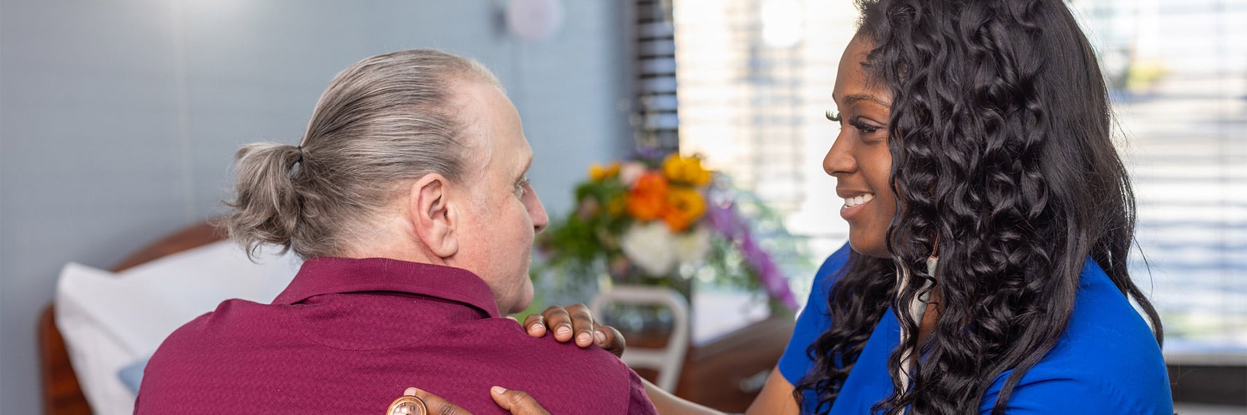 Nurse listening to patient's heartbeat at Cedar Creek Post Acute